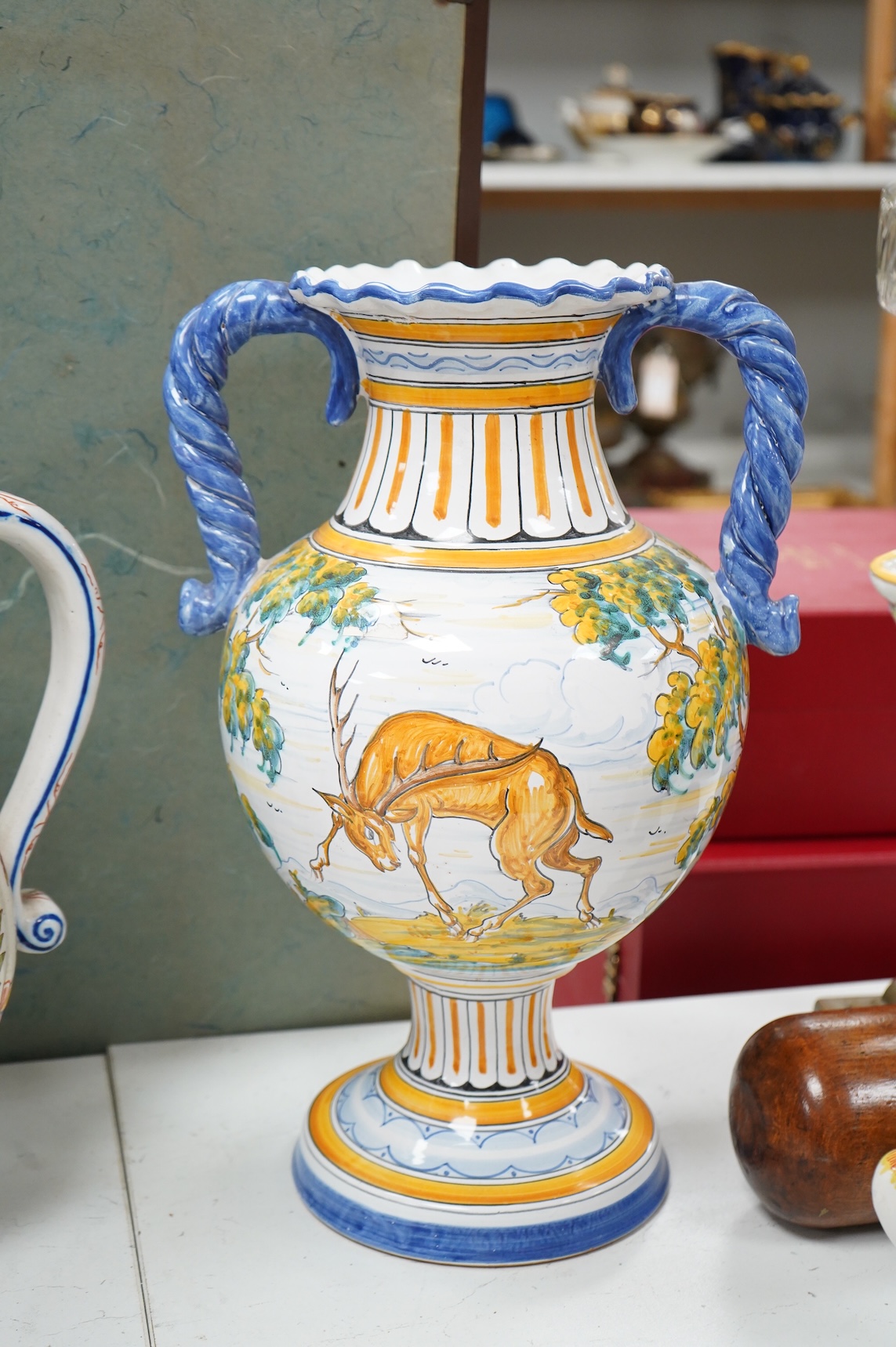 Two large French faience jugs and a vase, and a Talavera twin handled urn/vase, 44cm high